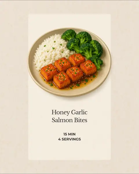 A styled photo of a plate featuring a meal of honey garlic salmon bites, rice, and broccoli with a peach-colored background.