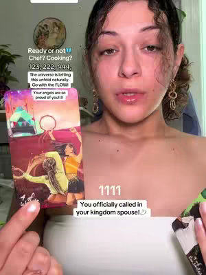 A woman with dark hair and wearing a white top holds a tarot card with an illustration featuring two figures. Text overlays include phrases about cooking and angelic guidance, and the number 1111 is displayed centrally.