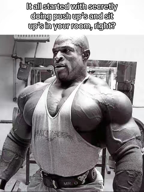Black and white image of a bodybuilder with massive muscles looking up with a serious expression, overlaid with text. The background is a generic indoor setting with various mechanical appurtenances.