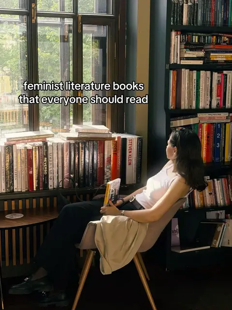 A woman sits in a chair angled toward a window and bookshelves with a book in hand. Overlayed text states the video topic.