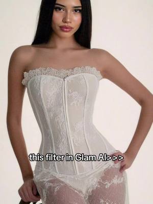 A young woman with long black hair poses in a strapless white lace bodice and a matching lace skirt. The background is plain, emphasizing the subject's figure and attire. Text overlayed at the bottom reads, 'this filter in Glam AI>>>'.