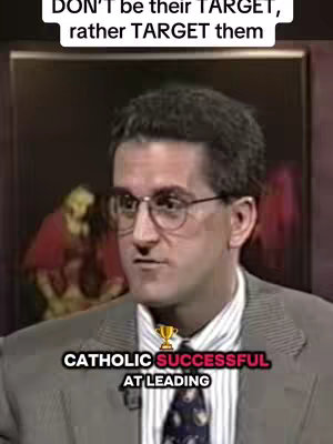 A man in a suit and glasses is the focal point of the image, set against a blurry, dark background. Text overlays at the top and bottom provide a message, accompanied by a small trophy icon. The man appears to be in a serious discussion, with a thoughtful expression.