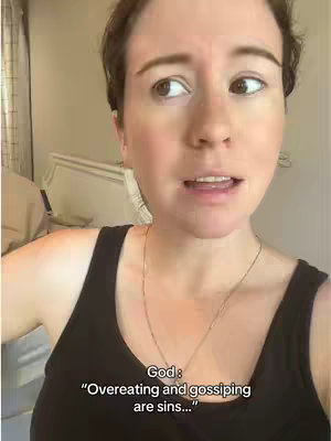 A woman is filmed in a selfie-style shot, looking slightly off-camera with a concerned or contemplative expression. She is wearing a black tank top and a thin gold necklace. Text overlayed at the bottom reads 'God: "Overeating and gossiping are sins..."'