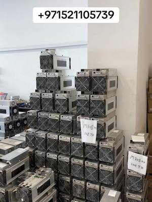 The cover image shows a warehouse scene filled with stacks of Whatsminer ASIC miners, indicating an industrial setting related to cryptocurrency mining. Miners are stacked high, suggesting a large inventory.