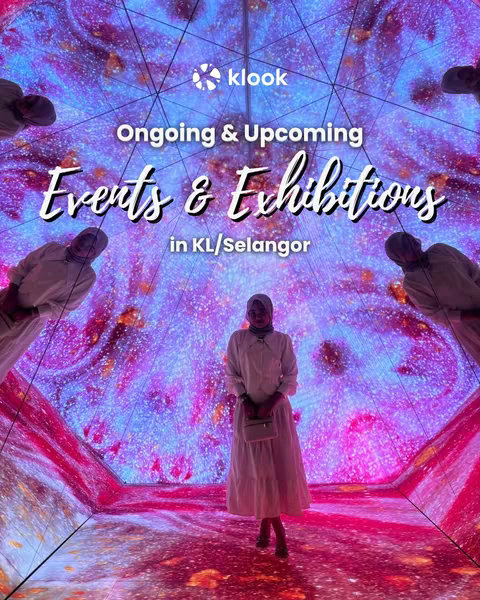 An indoor shot captures a woman in a light dress standing in the center of a colorful, immersive exhibition space. The walls and floor display a vibrant pink, blue, and purple patterned digital display creating a unique, dynamic environment. Above, text overlayed with the Klook logo lists "ongoing & upcoming events & exhibitions in KL/Selangor". The woman is shown from the mid-thigh up holding a small off-white purse. She has a hijab, and appears to be looking into the camera. Other figures are on the periphery, each similarly enveloped in what seems to be an interactive experience.