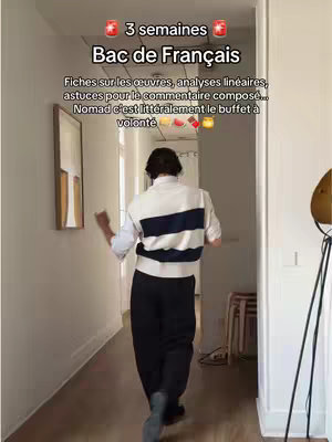A person is walking away from the camera in a well-lit hallway. The person is wearing a white shirt with a dark blue stripe across the chest. The hallway has white walls, and on the left, there is a framed picture. The floor is made of light-colored wood. Text overlays indicate the subject of the video.