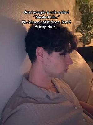 A man with dark, curly hair, turned in profile, sits against a wall, with text overlaid at the top that says, 'Just bought a coin called "MaybeCoin." No idea what it does, but it felt spiritual.' The lighting suggests an indoor setting.