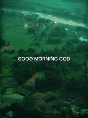 An aerial view featuring lush green terrain, possibly fields or a cultivated landscape. The image is tinted with a dominant green hue, creating a tranquil and natural atmosphere. Bold white text stating 'GOOD MORNING GOD' is overlaid at the center of the image.