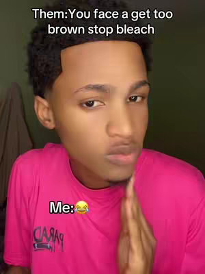 A young man with short, dark curly hair and a pink shirt is the focus. Text overlays above his head and near his mouth add to the image's message. He has a serious, slightly skeptical expression, with one hand up near his face. The background is simple, with a neutral-colored wall.
