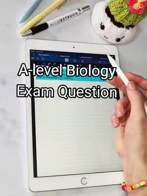An iPad is shown on a light-colored surface, with a hand holding a stylus. Overlay text reads "A-level Biology Exam Question." Pens and a small plant are visible in the background.