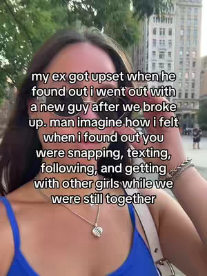 A woman in a blue top is the central focus, taking a selfie with an urban background featuring a building and trees. Overlayed text, in a clear white font, details a narrative regarding a relationship, placed above the woman's head. The background includes trees and a building, all presented in natural light.