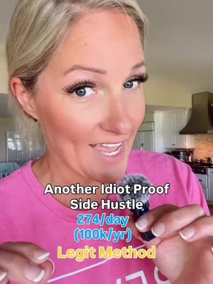 A woman with light blonde hair is centered in the frame, with a close-up shot highlighting her face. She has long eyelashes and is gazing at the camera with a slight smile. Her lips are slightly parted, and her skin appears smooth. She is wearing a pink t-shirt. In the background, there are hints of a kitchen setting. Text overlays are present, partially obscuring the image.
