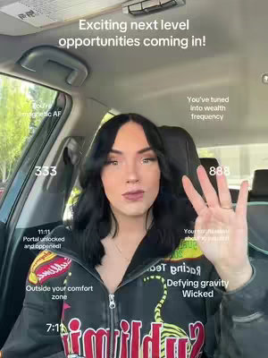 A woman is seated in a car, with a text overlay featuring various affirmations and numbers. The woman's expression is neutral as she holds up four fingers. The image has a modern, clean look, featuring overlaid text with a white font and the background is blurred car's interior.