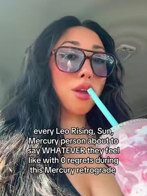 A woman with dark hair and sunglasses is inside a car, holding a drink with a straw, with text overlaid on the image. The woman is looking downwards at the drink.
