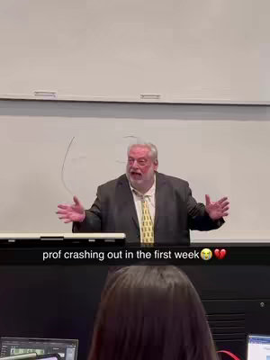 An elderly man in a suit is standing in front of a whiteboard, gesturing with his hands. Text overlayed on the image.