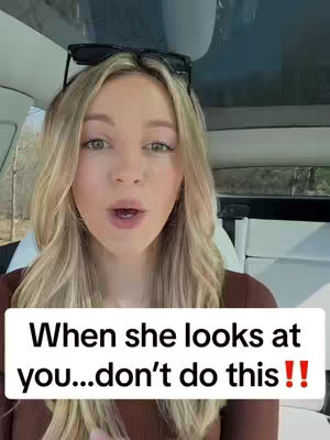 A blonde woman with sunglasses on her head is in a car, looking at the camera with an open mouth. Text on a box overlay reads, 'When she looks at you...dont' do this!!'