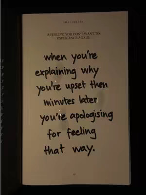 An image of a page from a book with handwriting. The top of the page has a title "A FEELING YOU DON'T WANT TO EXPERIENCE AGAIN" and the main text, written in a handwritten style, discusses the experience of explaining why one is upset, then apologizing for their feelings.