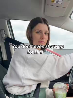 A woman in a white sweater is seated in a car, looking at the camera with a serious expression. Text overlayed on the image reads, "You don't even show up for Him." The setting appears to be outdoors on a cloudy day.