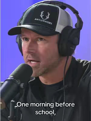 A man wearing a black cap with the word 'ANTLERWORX' on it, with headphones and a microphone in front of him. He appears to be talking, with text overlaid at the bottom.