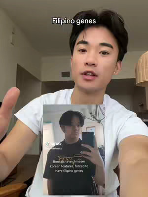 The cover image shows a young man in a white t-shirt holding an image in his hands, in a selfie style shot. The overlay text says 'Filipino genes'. The image held by the man shows another person, similar in age, wearing a back t-shirt, also taking a selfie, presumably holding their phone. There is a warm, neutral background.