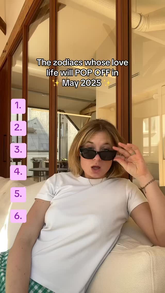 A woman sitting on a white couch with a neutral setting. She's wearing sunglasses and a white t-shirt. On the left side of the image, there are numbers in pink boxes.