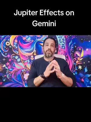 A man with a beard sits in front of a colorful celestial background. He is wearing a dark blue shirt and has his hands clasped in front of him. The text overlay reads \"Jupiter Effects on Gemini\".