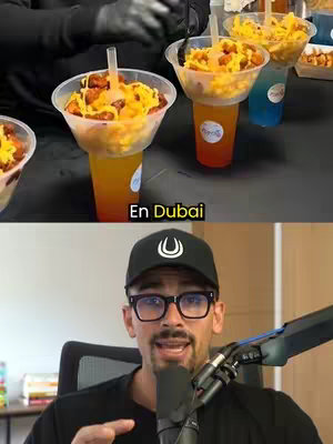 The image is split in two sections. The top shows hands preparing a street food item, a drink cup topped with food, on top of a container with some food. Below, a man in glasses and a black cap speaks into a microphone. There is a food and drink setup in the shot.