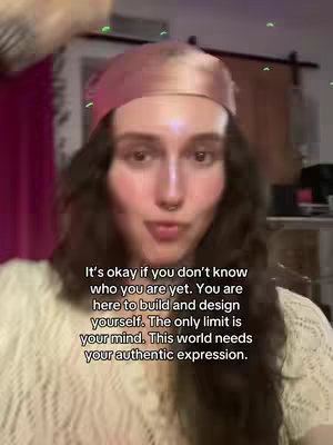 A woman with long, wavy brown hair is centered. She has a pink headscarf and a light, patterned top. Text overlays her face.