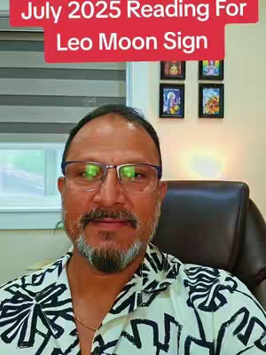 A man with glasses and a beard is centered in the frame, wearing a patterned short-sleeved shirt. Behind him is a blurred backdrop featuring decorative wall decor. The top section includes a red banner with white text.