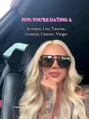 A woman with long blonde hair and large sunglasses is seated in a car. Text overlays float above the woman's head.  The background is blurred.