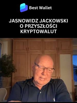The cover image shows a man in front of a room with wooden furniture. Above him is a black bar with the Best Wallet logo and the text, "JASNOWIDZ JACKOWSKI O PRZYSZŁOŚCI KRYPTOWALUT". The man is wearing glasses, looking down and slightly to his right, in a dark shirt. He seems to be in mid-sentence. The background suggests an indoor setting, perhaps a living room or study.
