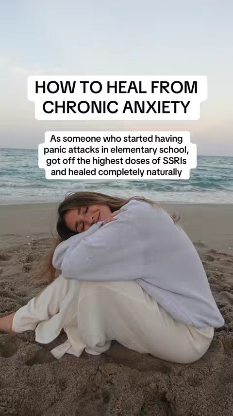 The cover image shows a woman sitting on a sandy beach. She is wearing a light-colored sweater and pants and is leaning with her forehead on her arms, in a relaxed pose. The background is a blurred view of the ocean and sky during twilight. Text overlayed appears in a white box.