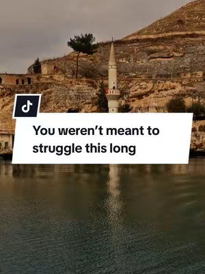 The cover image shows a scenic landscape with a body of water in the foreground, a town and high rock formations in the midground, and a cloudy sky. A white speech bubble, containing text, overlays the image near the lower-center.