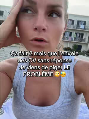 A selfie-style shot featuring a woman against a blurred outdoor background. She is wearing a light-colored tank top and has her hand on her head, with a concerned expression, and text overlayed on the image.