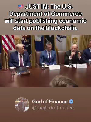 The image shows a screenshot of a news report. At the top is the headline: JUST IN: The U.S. Department of Commerce will start publishing economic data on the blockchain. Below is footage of a meeting around a large wooden table in what appears to be a government office. Several men in suits are seated around the table. At the bottom of the image, there is the account information from 'God of Finance' with a profile picture.