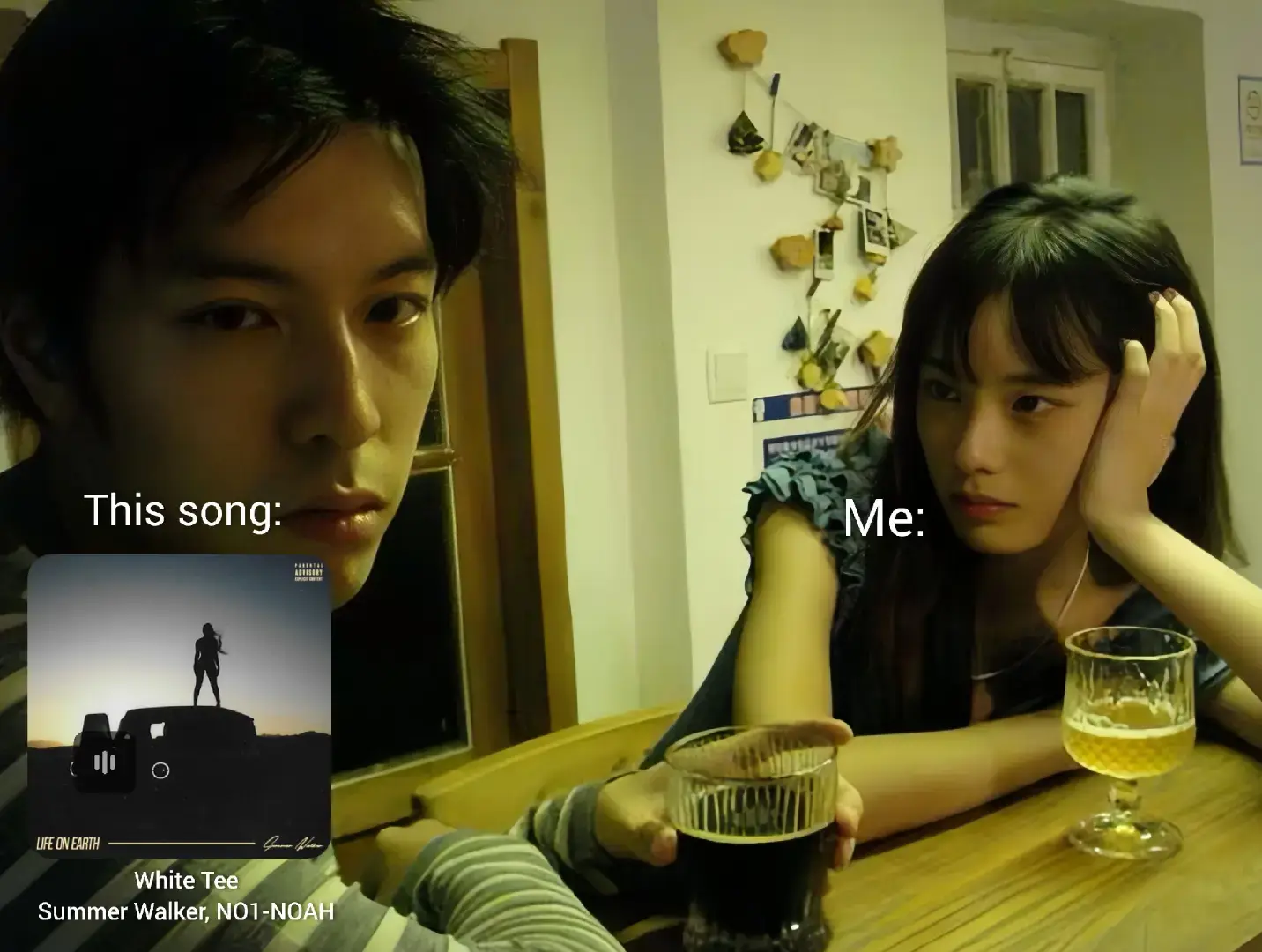 A split-screen image featuring a man on the left, looking directly at the camera with a neutral expression, and a woman on the right, resting her chin on her hand with a slightly bored expression. In the bottom left is an album cover for 'White Tee' featuring an image of a person on top of a truck, and text overlay adds labels like 'This song:' and 'Me:'. The background includes a wooden table, lit dimly.