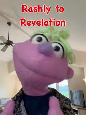 A selfie-style shot featuring a purple, puppet-like character with large eyes and green hair. The character is the central focus, positioned as if looking directly at the viewer. Above the character's head, text in red reads "Rashly to Revelation."