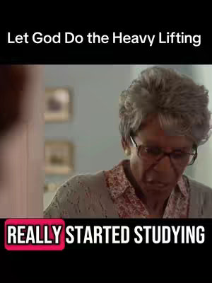 The image shows a scene from a movie with an older African-American woman, wearing glasses and a cardigan, appearing deep in thought. Overlay text reads 'REALLY STARTED STUDYING,' set against a red backdrop, indicating a comedic or relatable context. The photo is framed with the top part of the image bearing the text 'Let God Do the Heavy Lifting.'