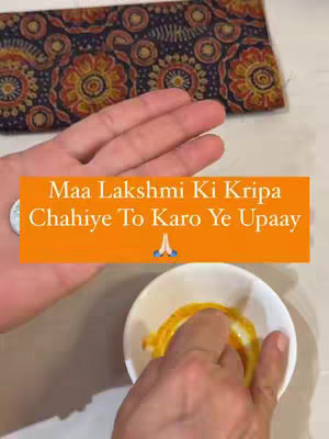 The cover image shows a hand holding a coin with an orange bar layered on top. The bar contains white text, and the background features a patterned cloth and a white bowl with a yellow substance.