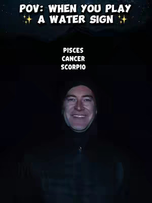 A dimly lit image features a man in a black hoodie, his face illuminated. Above his face, text states "POV: WHEN YOU PLAY A WATER SIGN," with star icons on either side. Below his face, the text lists astrological signs: "PISCES, CANCER, SCORPIO."