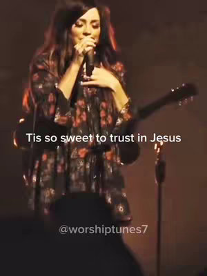 The cover image presents a woman on stage, holding a microphone and guitar, presumably singing. Text overlays the image, and the background is dark.