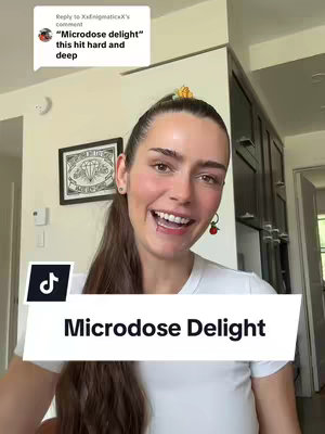 The cover image features a smiling woman with long, dark hair, wearing a white t-shirt and a small earring. She appears to be in a well-lit interior with wooden cabinets visible in the background. A white rectangle with black text overlays her chest, and the TikTok logo is in the bottom left corner. There is also text in a comment bubble at the top.