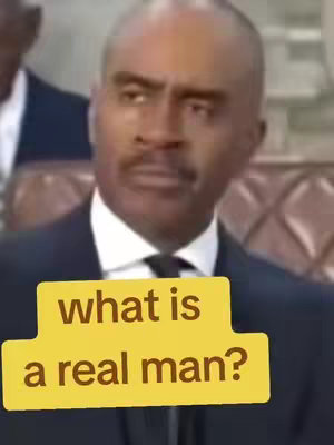The cover image shows a medium shot of a man in a dark suit. The man has a mustache and is looking slightly to the side. Overlaid on the image is a yellow rectangular box with the text "what is a real man?" in a dark brown font.