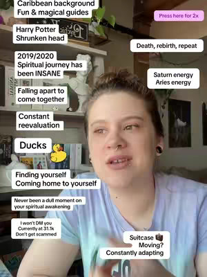 A woman with light skin and brown hair appears in a selfie-style video. She is speaking, with text bubbles and other information overlaid on the image. The background isn't in focus, but it seems to be a room with a shelf of books and knick-knacks. She wears a casual, light blue t-shirt and has a nose piercing and small black earrings. Various text overlays are placed around her head, including phrases like "Caribbean background" and "Finding yourself." The overall composition presents an informal, chatty video.