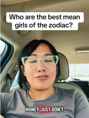 A woman with dark hair and glasses is seated in a car, looking toward the camera. Text overlays read, 'Who are the best mean girls of the zodiac?' and 'HONEY JUST DON'T.'