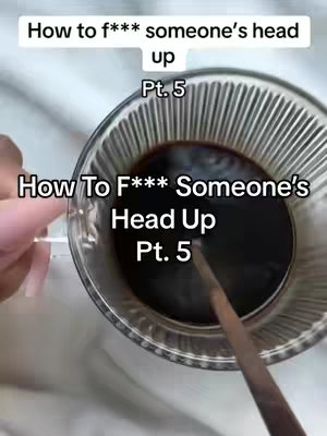 The image is a top-down shot of a glass of dark liquid, likely coffee or tea, with a wooden stirrer inside and a hand holding the glass. The surface the glass sits on appears to be a light-colored, possibly white, smooth surface. The text overlay is white and is positioned at the top left and below the top half of the image.