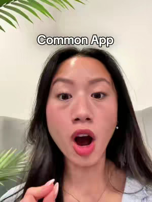 A young woman with long black hair is looking at the camera with a surprised expression, her mouth open. Above her head is the text "Common App". Background elements include a section of a light grey sofa, and the edge of some green foliage.