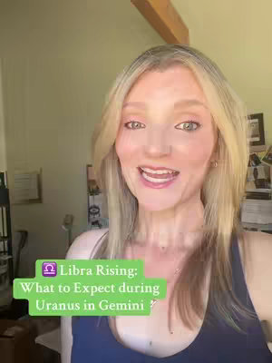 A woman with blonde hair is centered in a bright, indoor setting. She has rosy cheeks and is smiling while speaking. A green rectangle with text is overlaid in the bottom-left. Behind her are wooden accents and a partial view of what might be other decorative items.