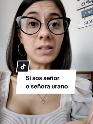 A woman with dark hair and glasses looks directly at the camera. A white and black text overlay is placed at the bottom with a TikTok logo in the top left corner.