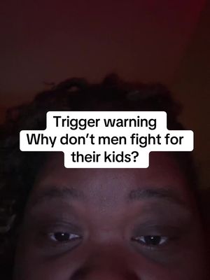 The cover image is a close-up of a person's face from the forehead down, with the top of the head and curly hair visible in a dim setting. The person has brown skin and is looking directly at the viewer. The eyes are prominent, and the lighting is subdued. Overlaid on the image is a white rectangle containing the text 'Trigger warning' on the first line, followed by the question 'Why don't men fight for their kids?' in a sans-serif font.